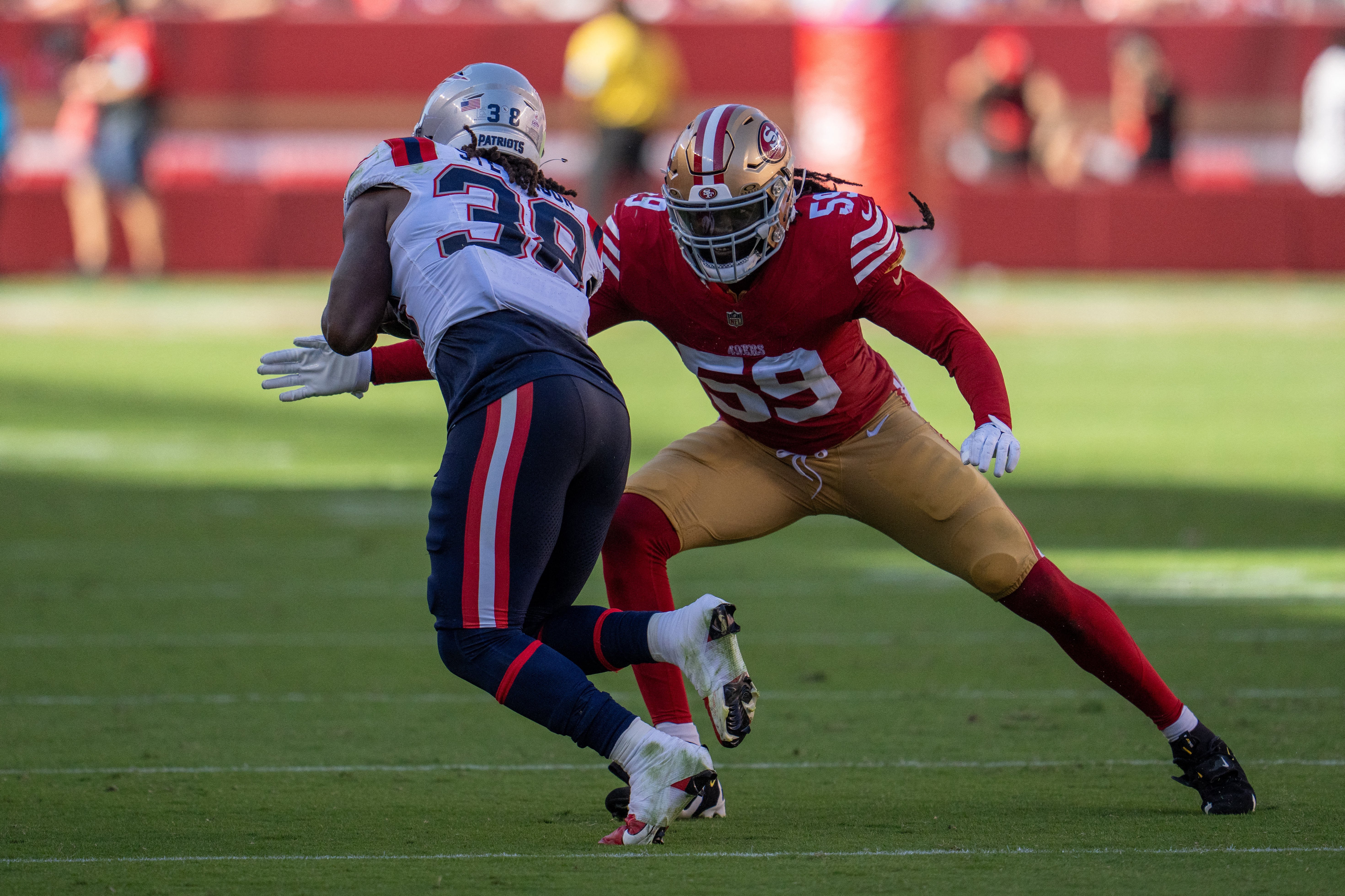 San Francisco 49ers linebacker De'Vondre Campbell (59) tackles New England Patriots running back Rhamondre Stevenson (38) during the fourth quarter at Levi's Stadium. Photo Credit: Neville E. Guard-Imagn Images