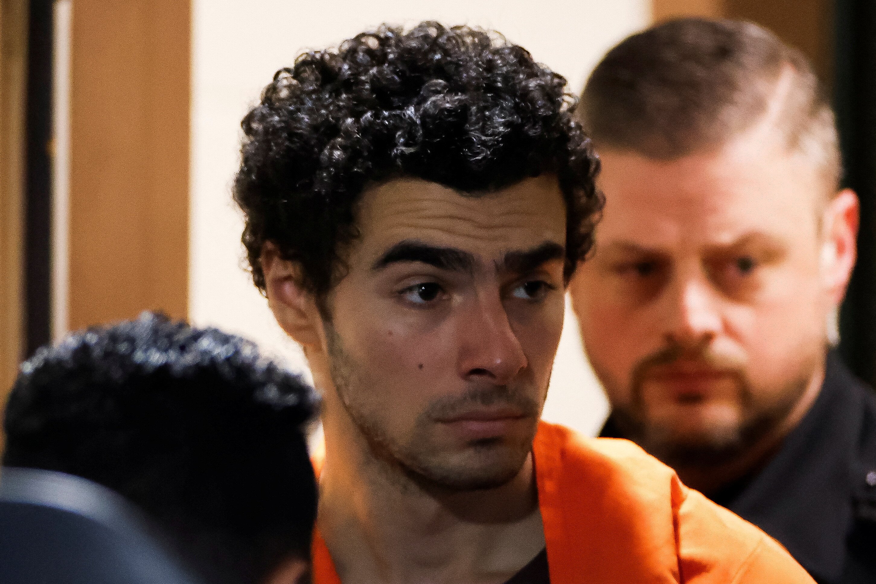 Luigi Mangione, 26, a suspect in the New York City killing of UnitedHealth executive Brian Thompson, is escorted after an extradition hearing at Blair County Court House in Hollidaysburg, Pennsylvania, U.S. December 10, 2024. REUTERS/Eduardo Munoz