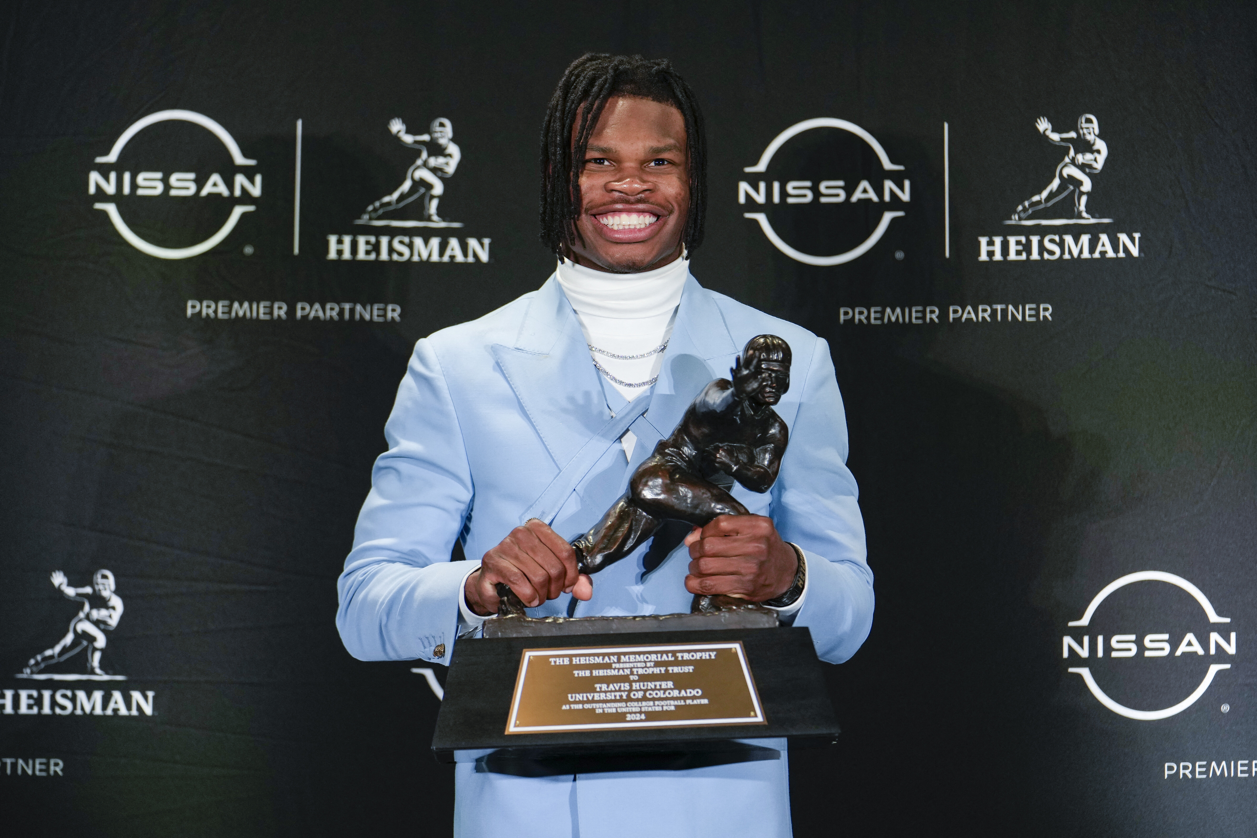 Colorado Buffaloes wide receiver/cornerback Travis Hunter poses for a photo after winning the Heisman Trophy award during the 2024 Heisman Trophy Presentation. Photo Credit: Lucas Boland-Imagn Images