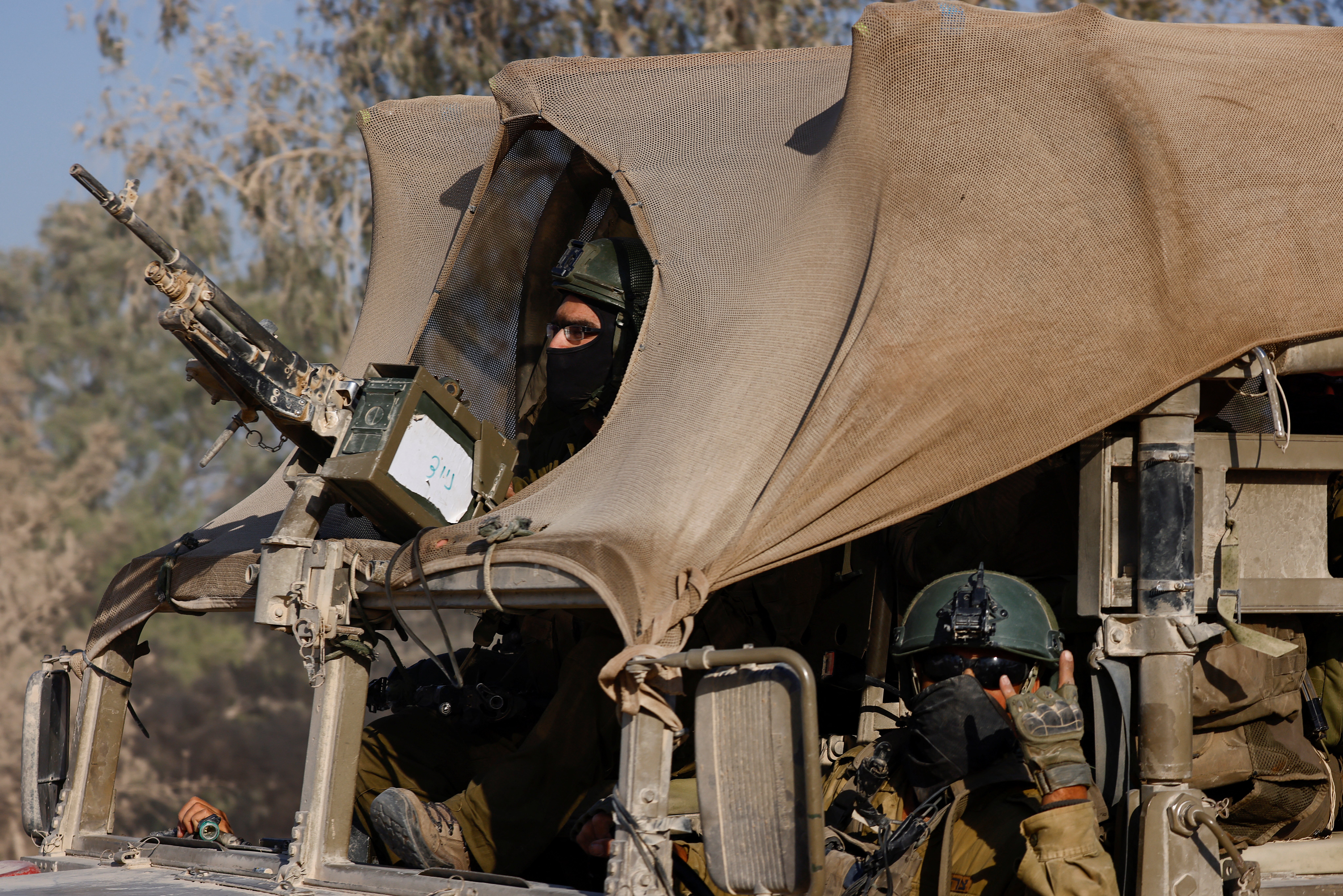 An Israeli soldier gestures while in a military vehicle, amid the Israel-Hamas conflict, near the Israel-Gaza border, in Israel, June 23, 2024. REUTERS/Amir Cohen