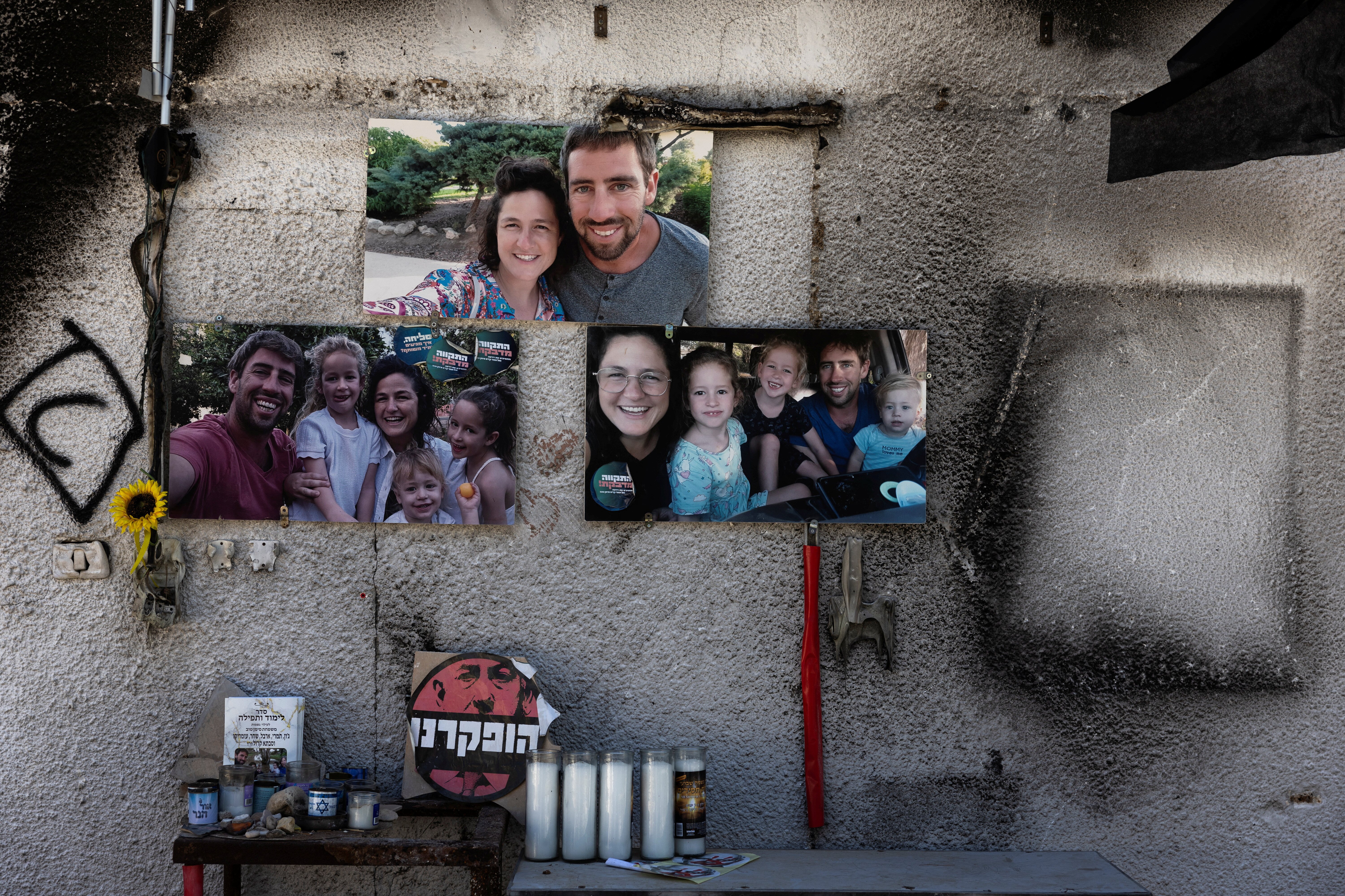 Portraits of the Siman Tov family consisting of Yonatan (Johnny) Siman Tov, Tamar Kedem-Siman Tov, 6-year-old twins Shahar and Arbel and 4-year-old Omer who were all killed during the deadly October 7 attack, are displayed nearly a year since the attack by Hamas, in Kibbutz Nir Oz, southern Israel, September 30, 2024. REUTERS/Amir Cohe