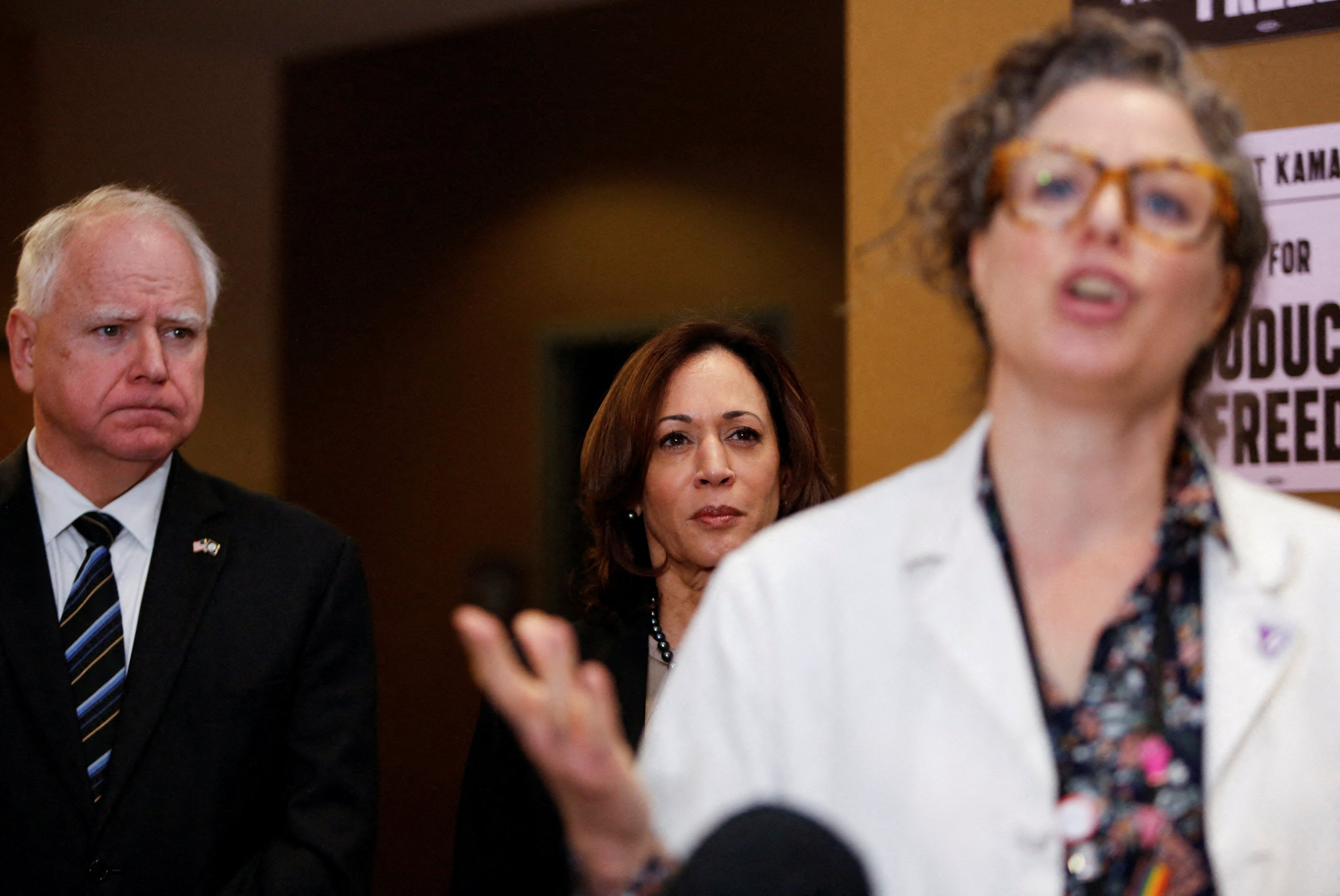 U.S. Vice President Kamala Harris and Minnesota Governor Tim Walz listen to Dr. Sarah Traxler as Harris visits the St. Paul Health Center, a clinic that performs abortions, in St. Paul, Minnesota, U.S., March 14, 2024. REUTERS/Nicole Neri/File Photo