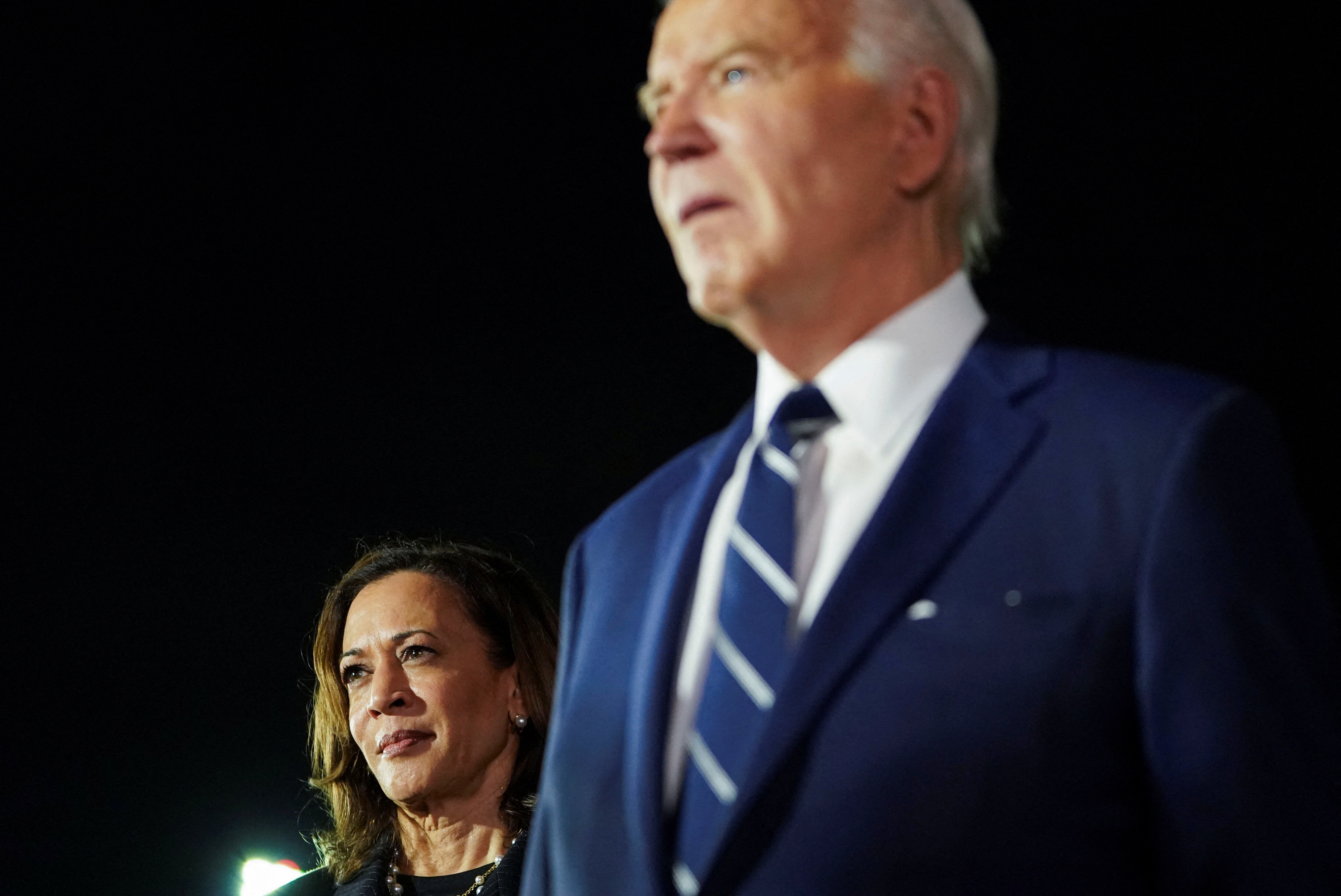 U.S. President Joe Biden and Vice President Kamala Harris look on at Joint Base Andrews in Maryland, U.S., August 1, 2024. REUTERS/Nathan Howard