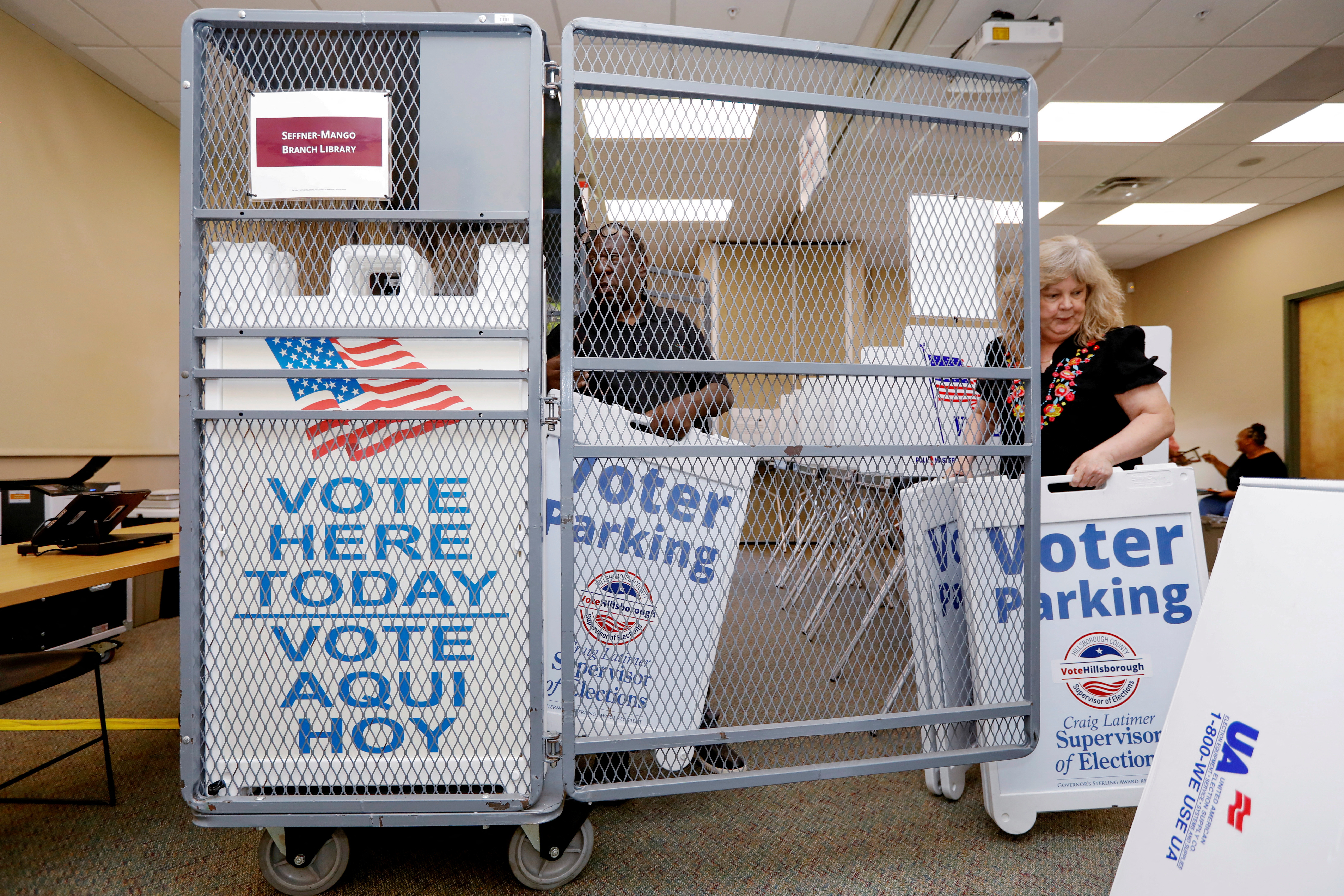 Poll workers with the Hillsborough County Supervisor of Elections Office, work during the setup of early voting equipment at the Seffner-Mango Branch Library in Seffner, Florida, U.S., August 2, 2024. REUTERS/Octavio Jones