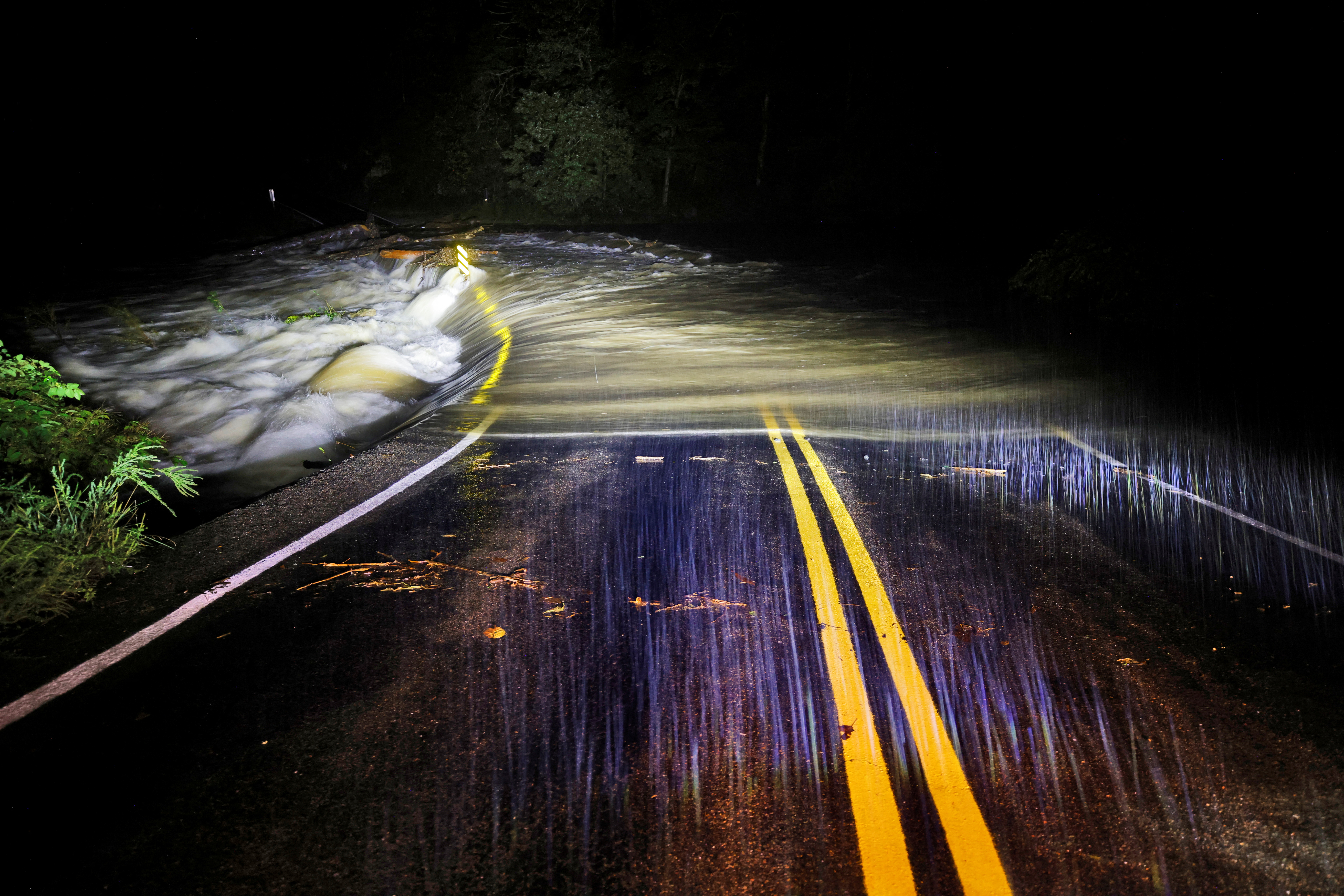 Flood waters wash over Guy Ford Road bridge on the Watauga River as Hurricane Helene approaches in the North Carolina mountains, in Sugar Grove, North Carolina, U.S. September 26, 2024. REUTERS/Jonathan Drak