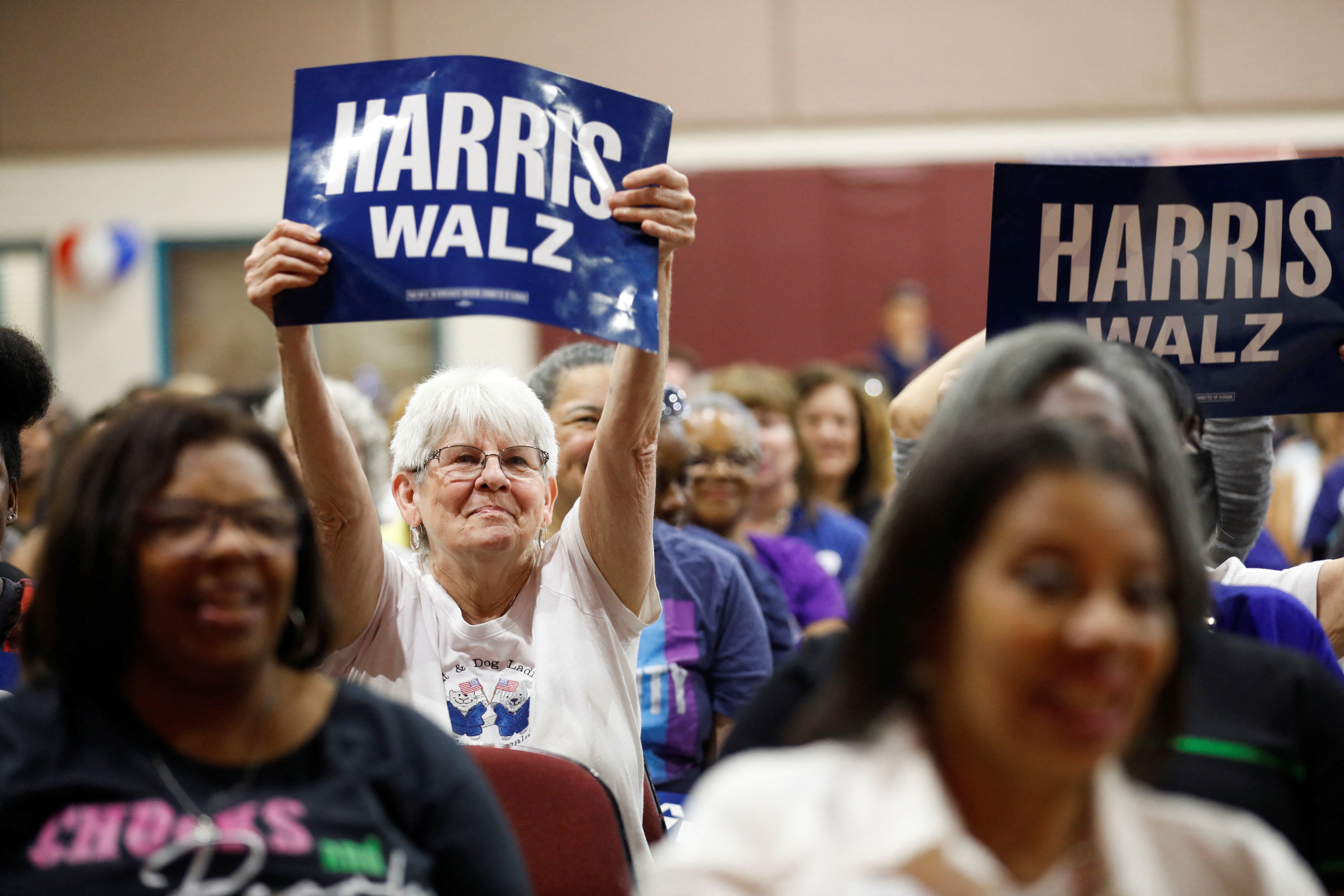 Supporters for Democratic presidential nominee and U.S. Vice President Kamala Harris and vice presidential nominee Minnesota Governor Tim Walz, wave campaign signs during of the Florida Democratic Party and Team Harris-Walz for Florida Tampa Women’s Rights event at the Victor Crist Community Center in Tampa, Florida, U.S. August 24, 2024. REUTERS/Octavio Jones