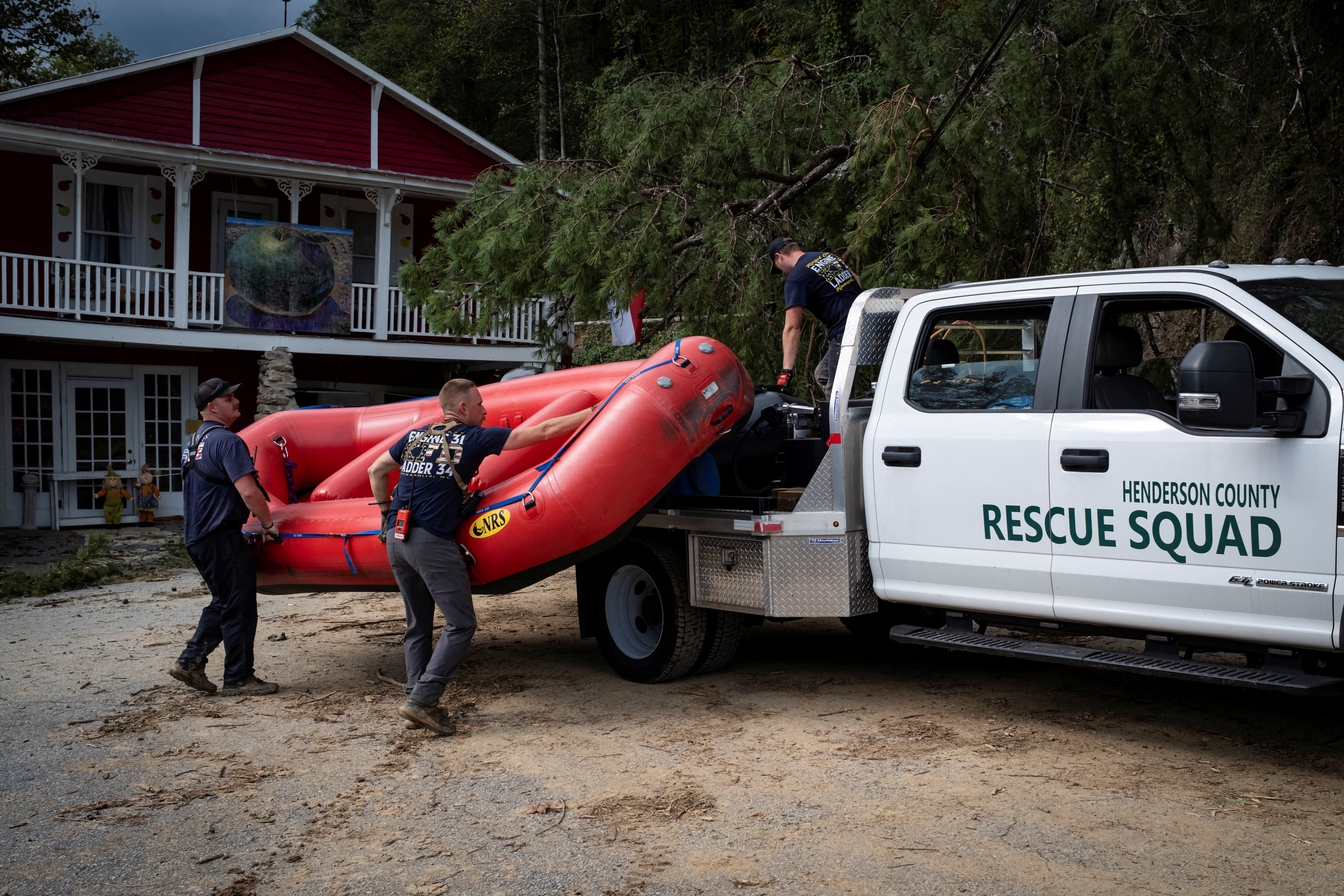 Fire and Rescue members unload a dinghy boat off a truck, following the passing of Hurricane Helene, in Bat Cave, North Carolina, U.S., September 30, 2024. REUTERS/Marco Bello