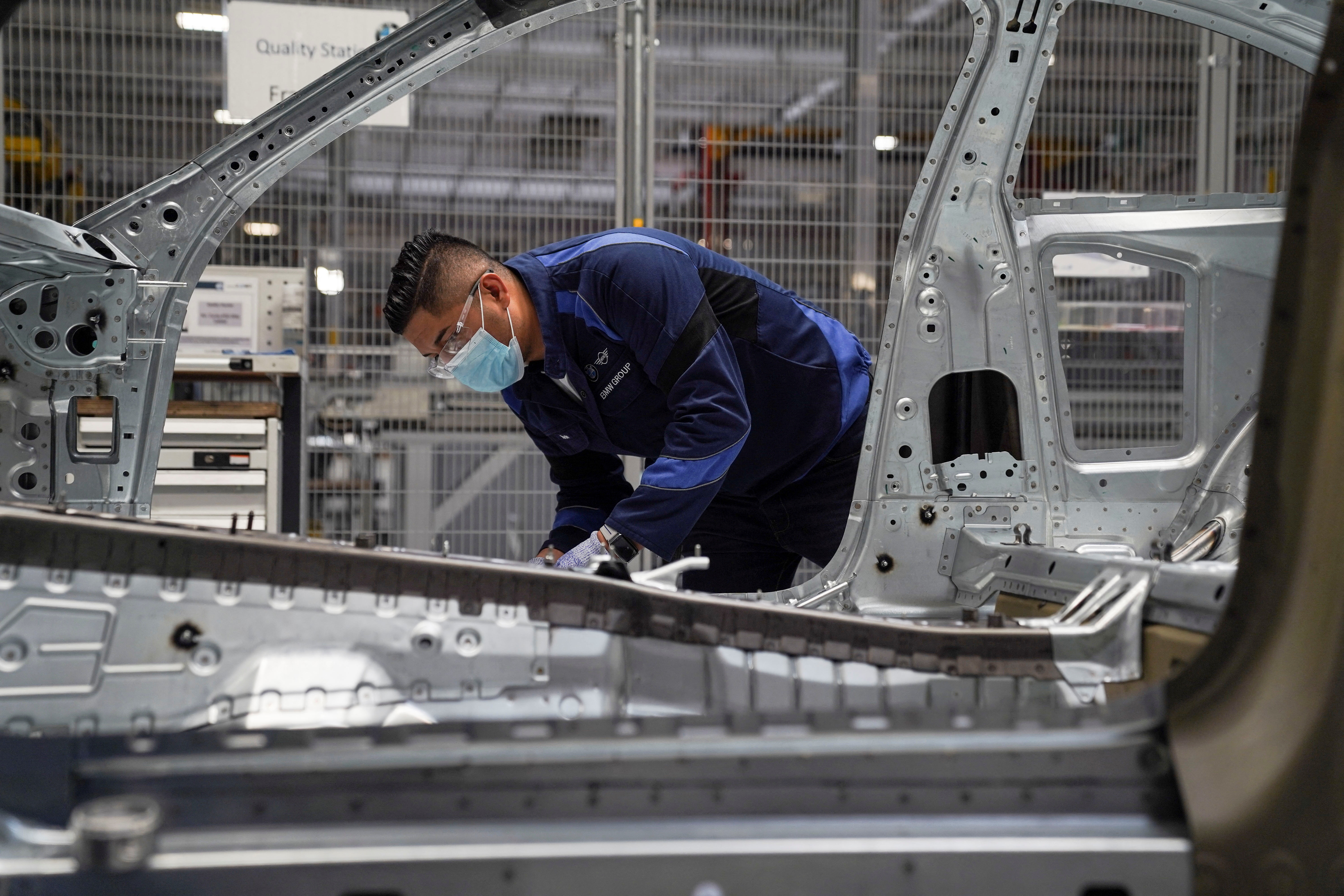 An employee checks the quality of a BMW car part during a media tour at the plant of German automaker BMW in San Luis Potosi, Mexico, February 3, 2023. REUTERS/Toya Sarno Jordan