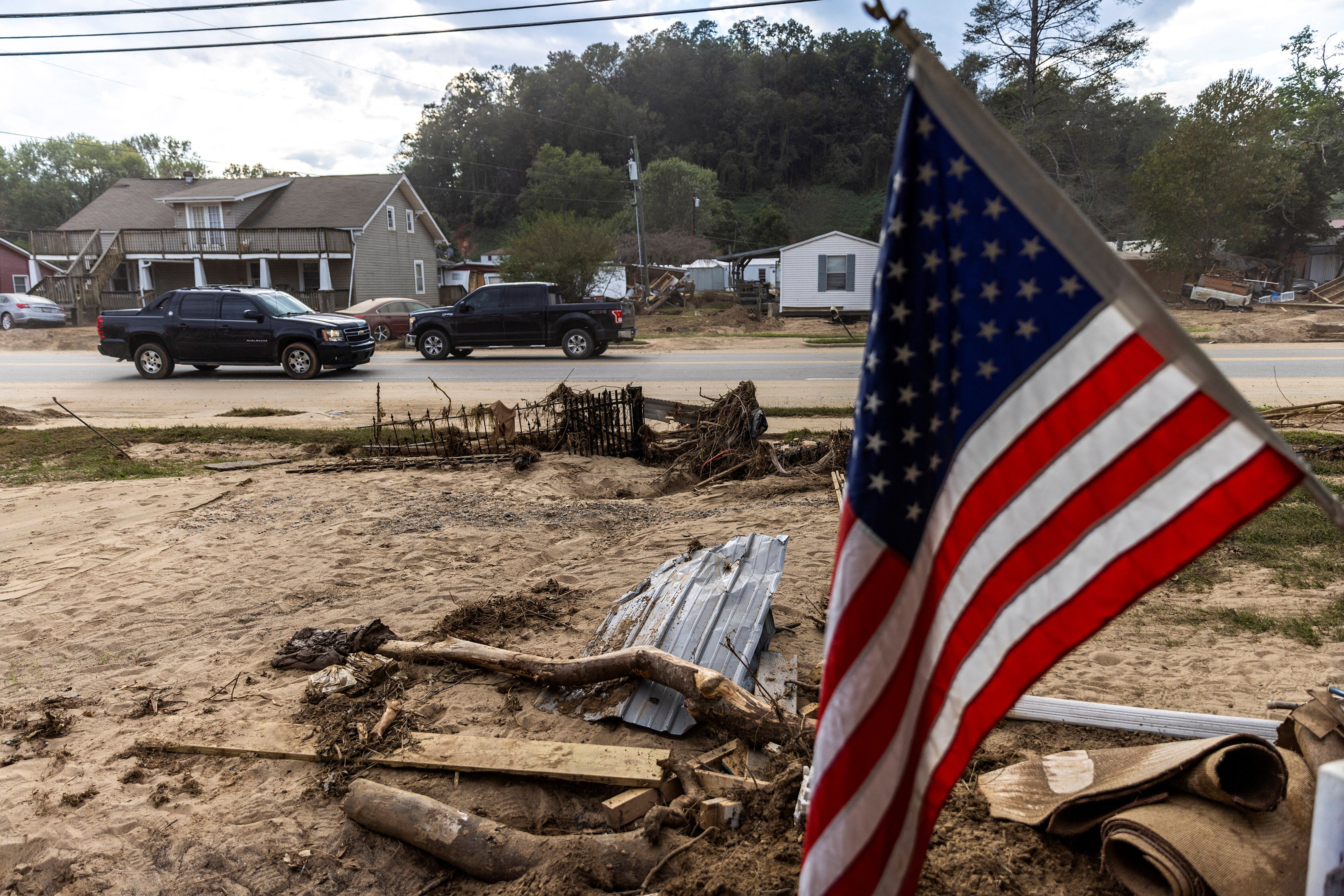 Cars drive along a road affected by floods following the passing of Hurricane Helene in Old Fort, North Carolina, U.S., October 4, 2024. REUTERS/Eduardo Munoz