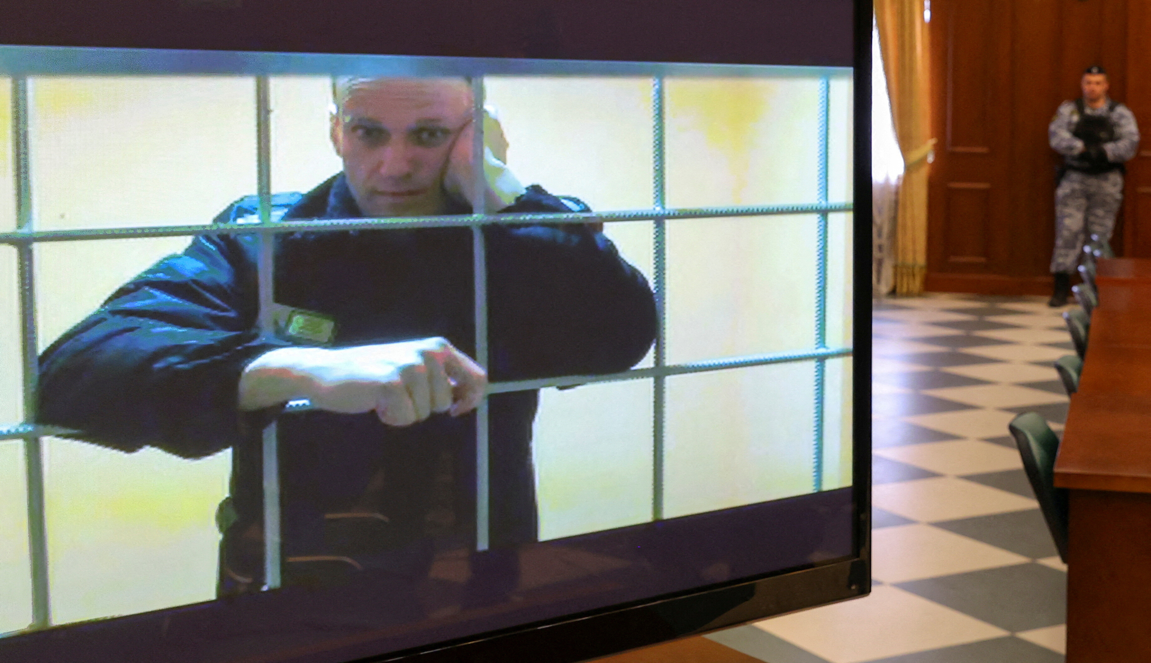 Russian opposition leader Alexei Navalny is seen on a screen via a video link from the IK-2 corrective penal colony in Pokrov during a court hearing to consider an appeal against his prison sentence in Moscow, Russia May 24, 2022. REUTERS/Evgenia Novozhenina