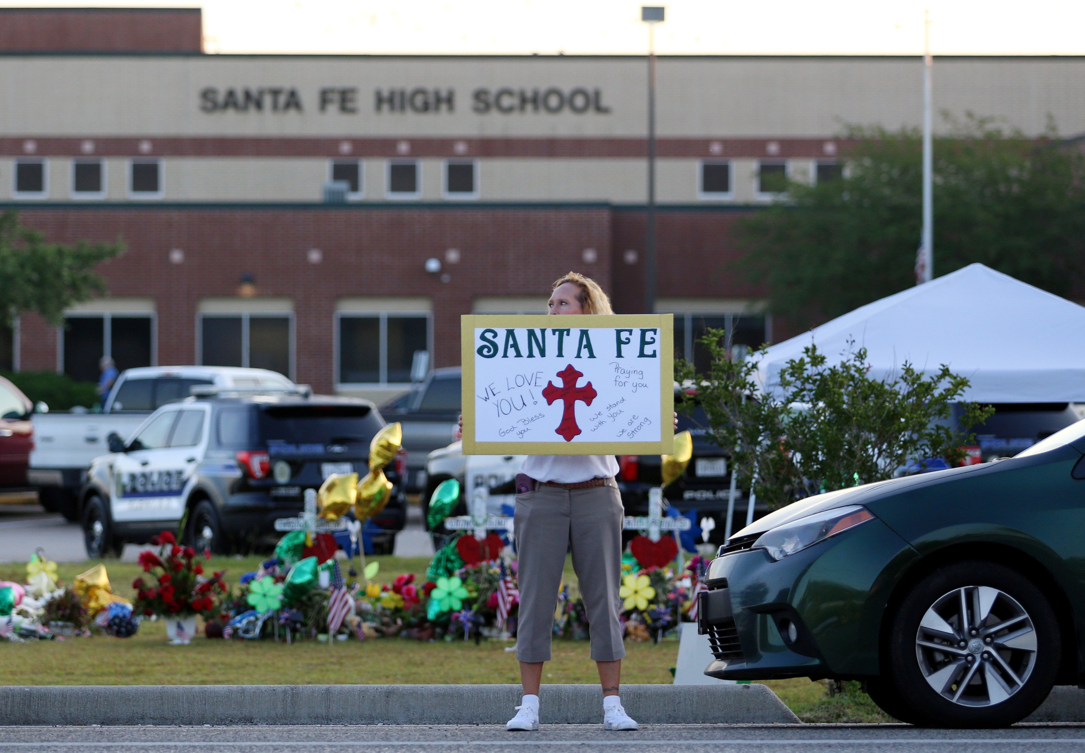 A member of the community shows her support outside Santa Fe High School as students return for the first day of class since a deadly mass shooting in Santa Fe, Texas, U.S., May 29, 2018. REUTERS/Pu Ying Huang