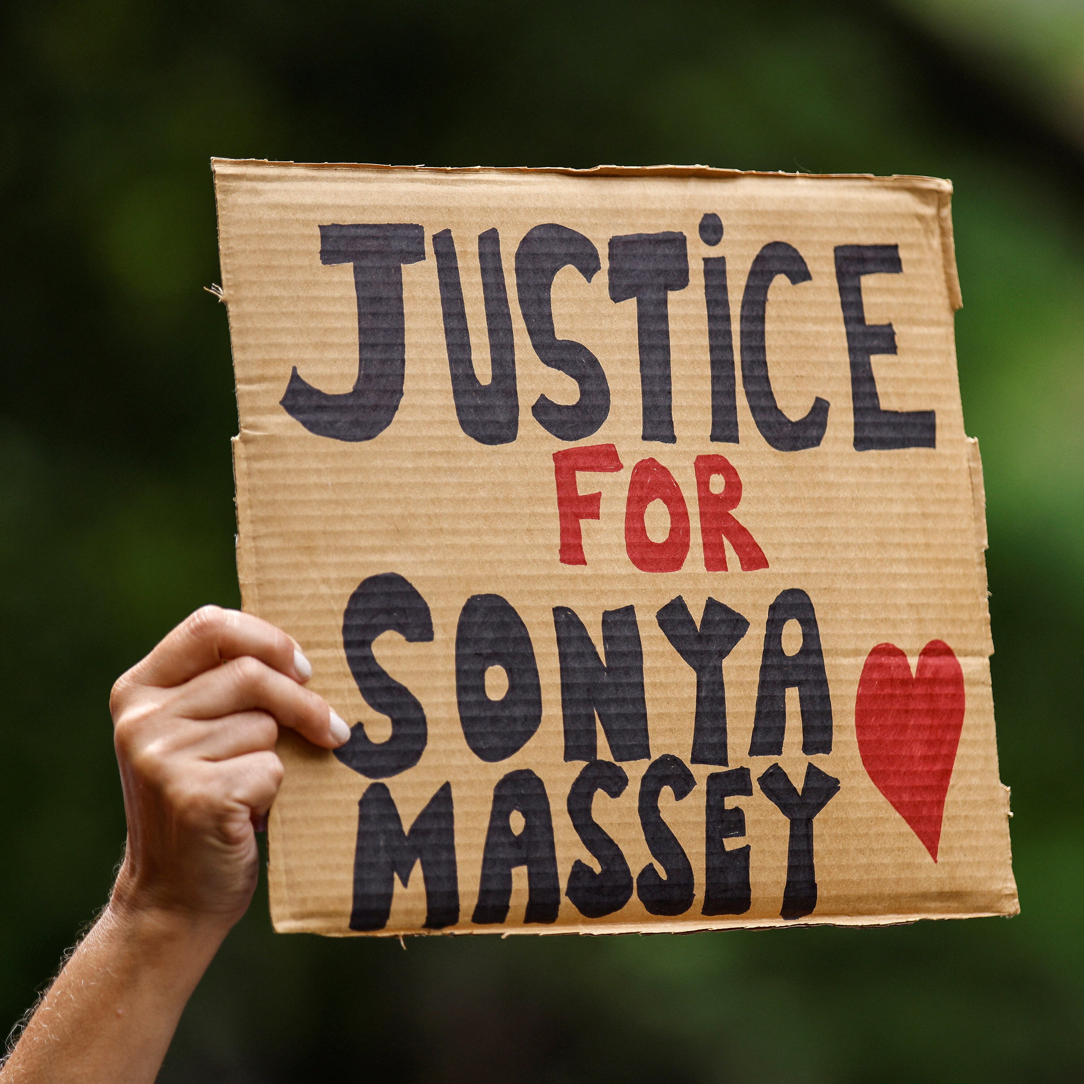 A woman holds a banner as people take part in a rally and vigil for Sonya Massey, who was shot and killed by Sangamon County Sheriff's Deputies on July 6, at Washington Square Park in New York City, U.S., July 28, 2024. REUTERS/Eduardo Munoz