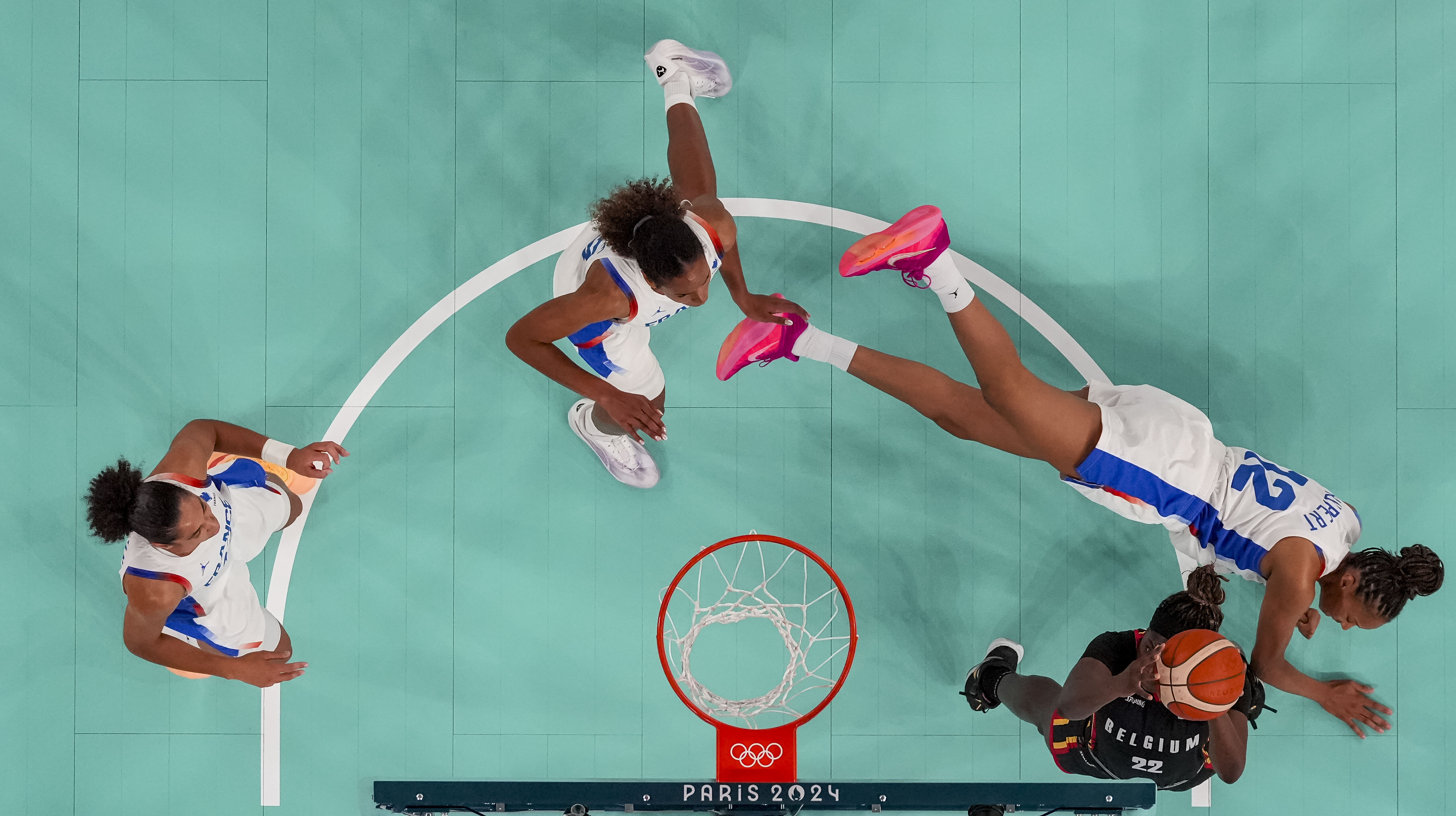 Aug 9, 2024; Paris, France; Belgium small forward Bethy Mununga (22) attempts to shoot while France centre Iliana Rupert (12) falls to the ground in a women's basketball semifinal game during the Paris 2024 Olympic Summer Games at Accor Arena. Credit: Kyle Terada-USA TODAY Sports