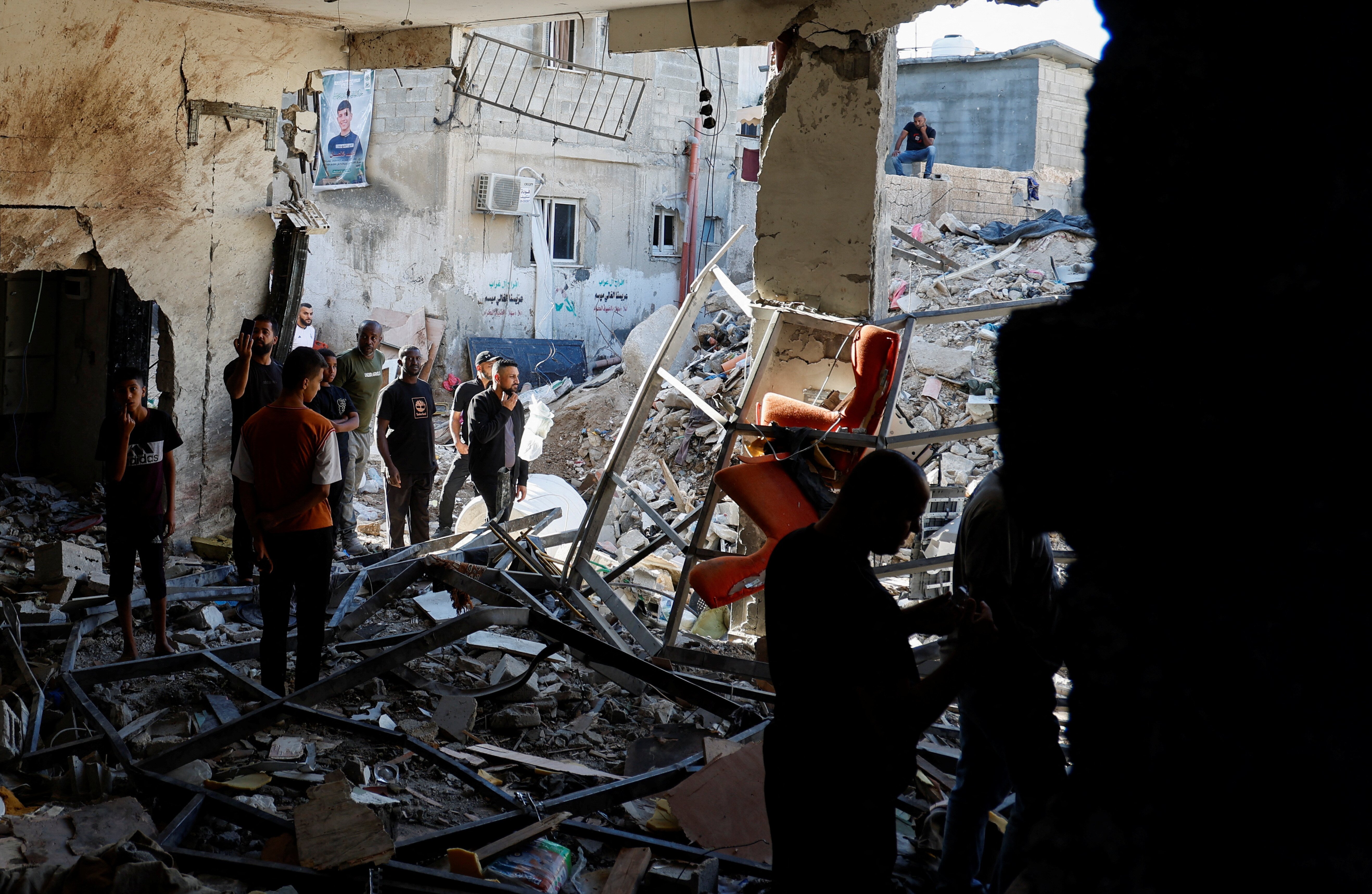 Palestinians inspect the damage at the site of an Israeli air strike in Tulkarm camp, in Tulkarm, in the Israeli-occupied West Bank, October 4, 2024. REUTERS/Raneen Sawafta