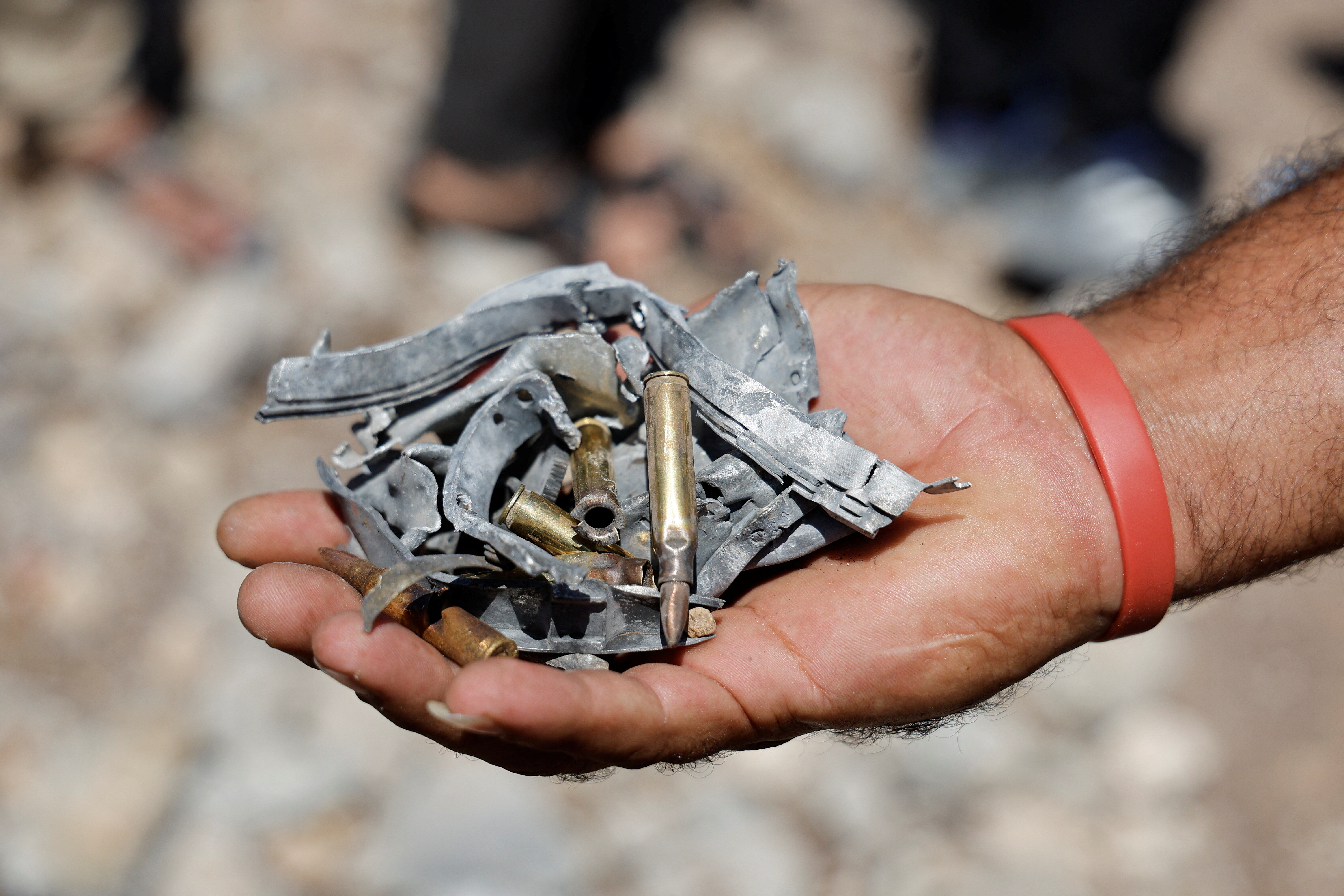 A man holds bullet shells and shrapnels from an Israeli rocket following an Israeli air strike near Tulkarm, in the Israeli-occupied West Bank, August 3, 2024. REUTERS/Raneen Sawafta